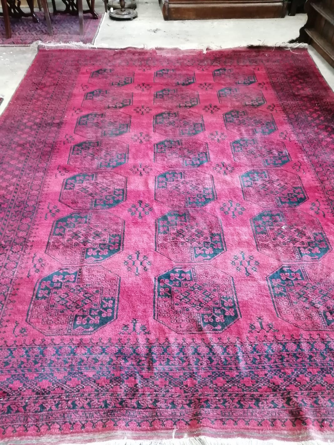 An Afghan red ground carpet (a.f.), 370 x 278cm